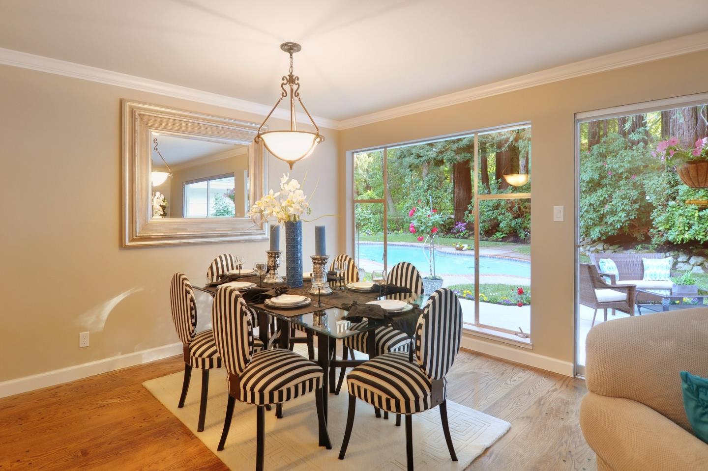 3470 Tripp Road Woodside, CA 94062 - Photo 5 of 34 a dining room with furniture large windows and wooden floor