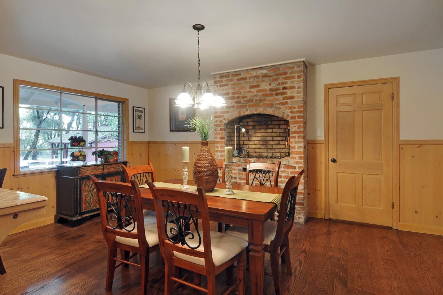 3470 Tripp Road Woodside, CA 94062 - Photo 8 of 34 a dining room with furniture a chandelier and wooden floor