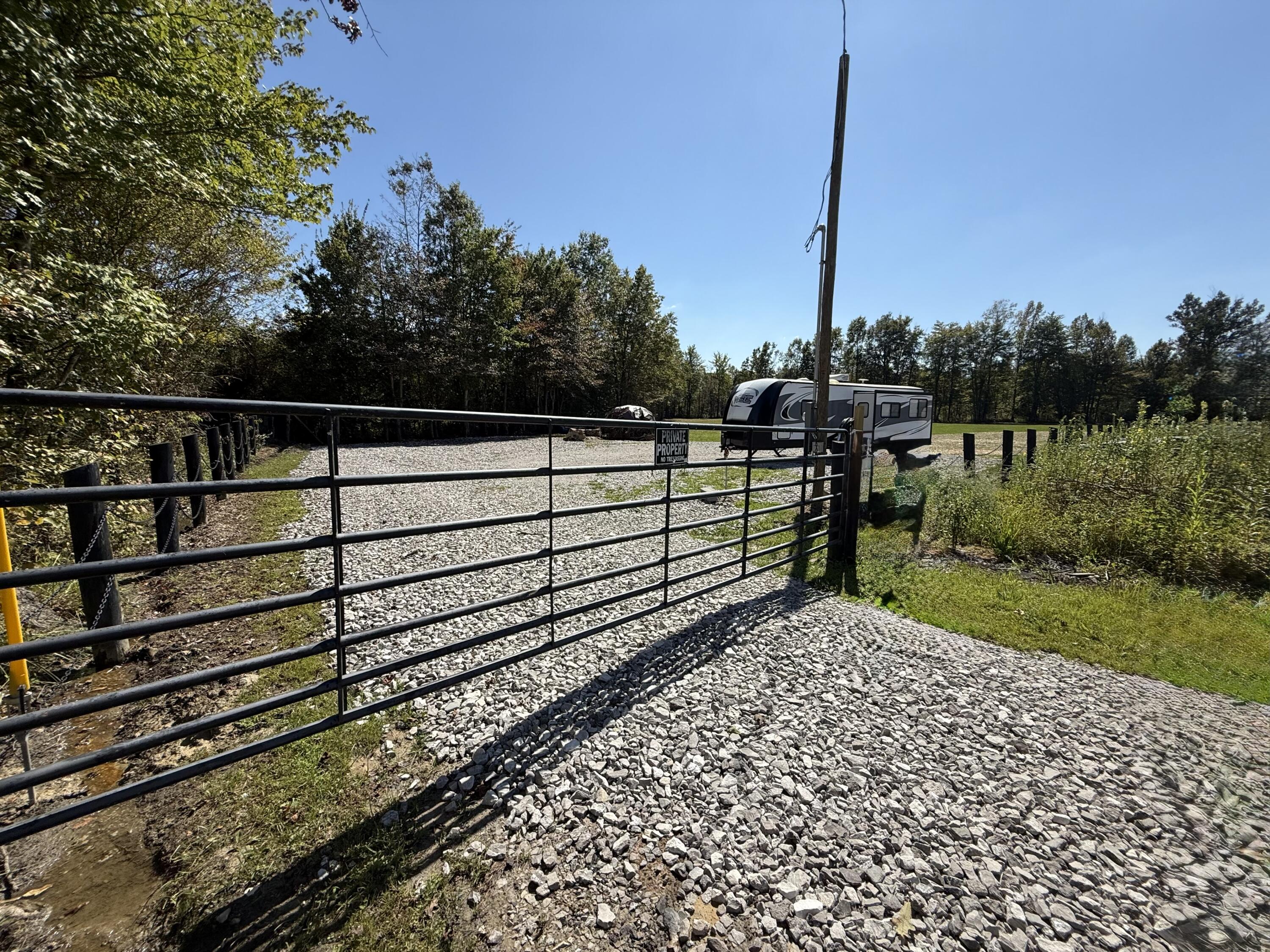 4386 South Laurel Road London, KY 40744 - Photo 2 of 35 Gate leading in the property with camper and fire pit