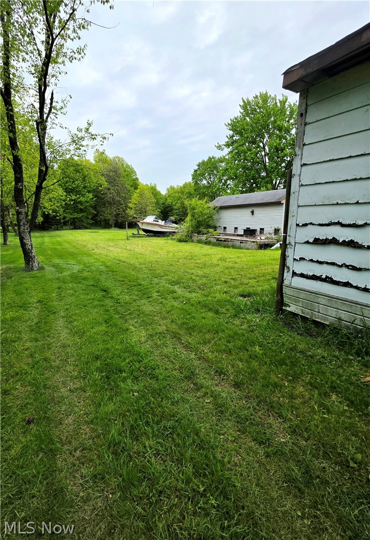 6270 Fairview Road Youngstown, OH 44515 - Photo 3 of 3 Expansive green lawn with mature trees, offering ample outdoor space