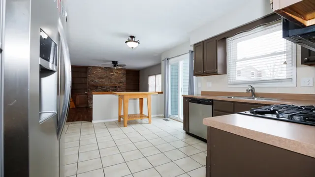 a view of a kitchen with wooden floor and a sink