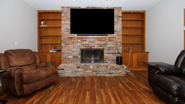 a living room with furniture a flat screen tv and a fireplace