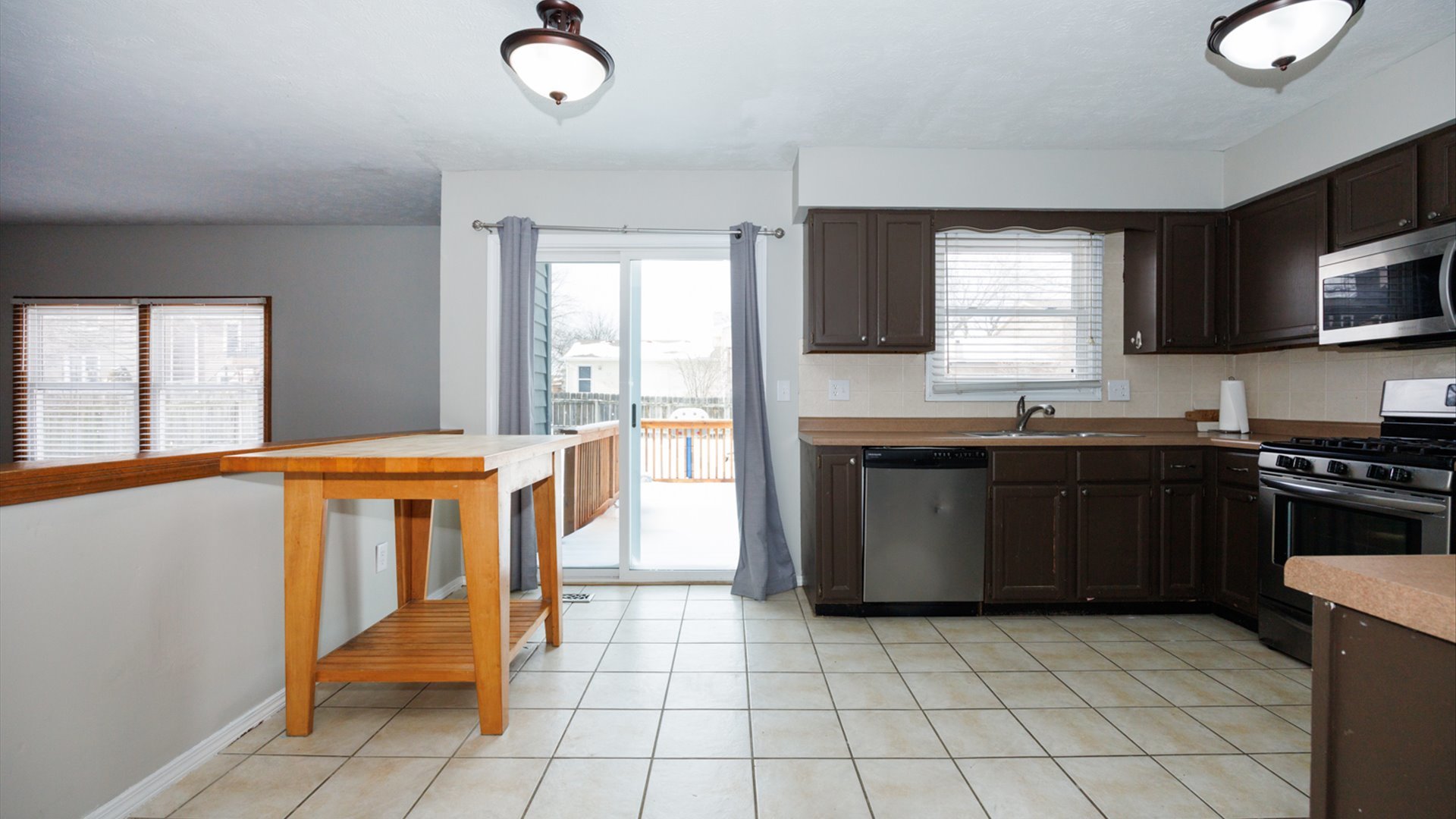 2007 Fallen Oak Road Bloomington, IL 61704 - Photo 12 of 44 a kitchen with stainless steel appliances granite countertop a stove a sink and a microwave