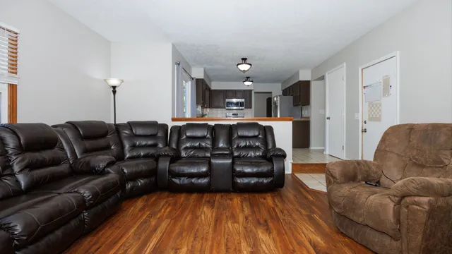 a living room with furniture and wooden floor