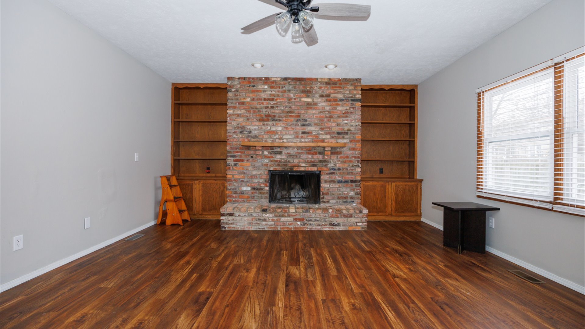 2007 Fallen Oak Road Bloomington, IL 61704 - Photo 14 of 44 a view of a livingroom with a fireplace and wooden floor