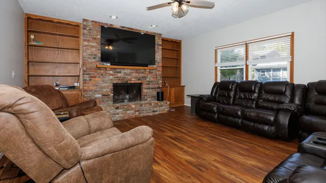 a living room with furniture a fireplace and a flat screen tv