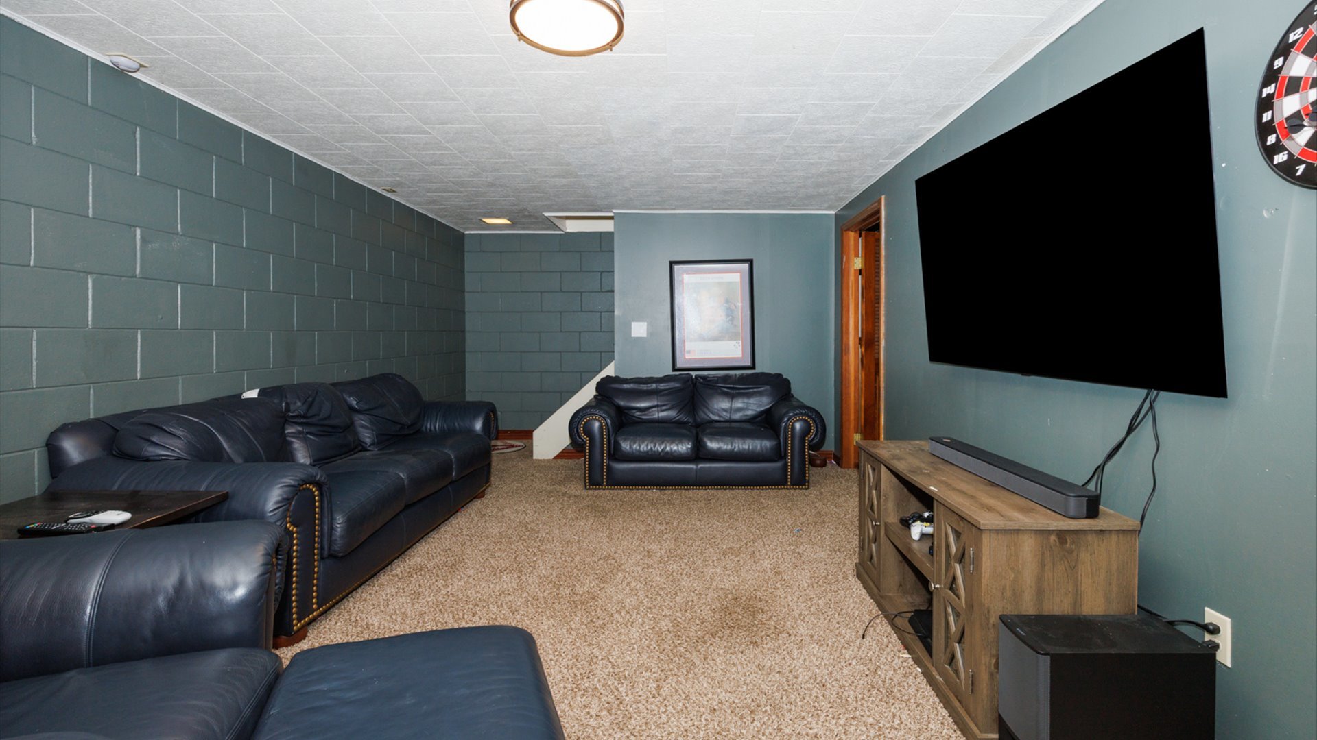 2007 Fallen Oak Road Bloomington, IL 61704 - Photo 38 of 50 a living room with a couch and a flat screen tv