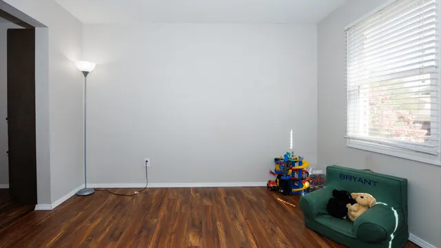 a view of a room with wooden floor and lounge chairs