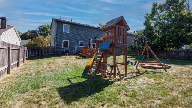 a view of a house with a yard and sitting area