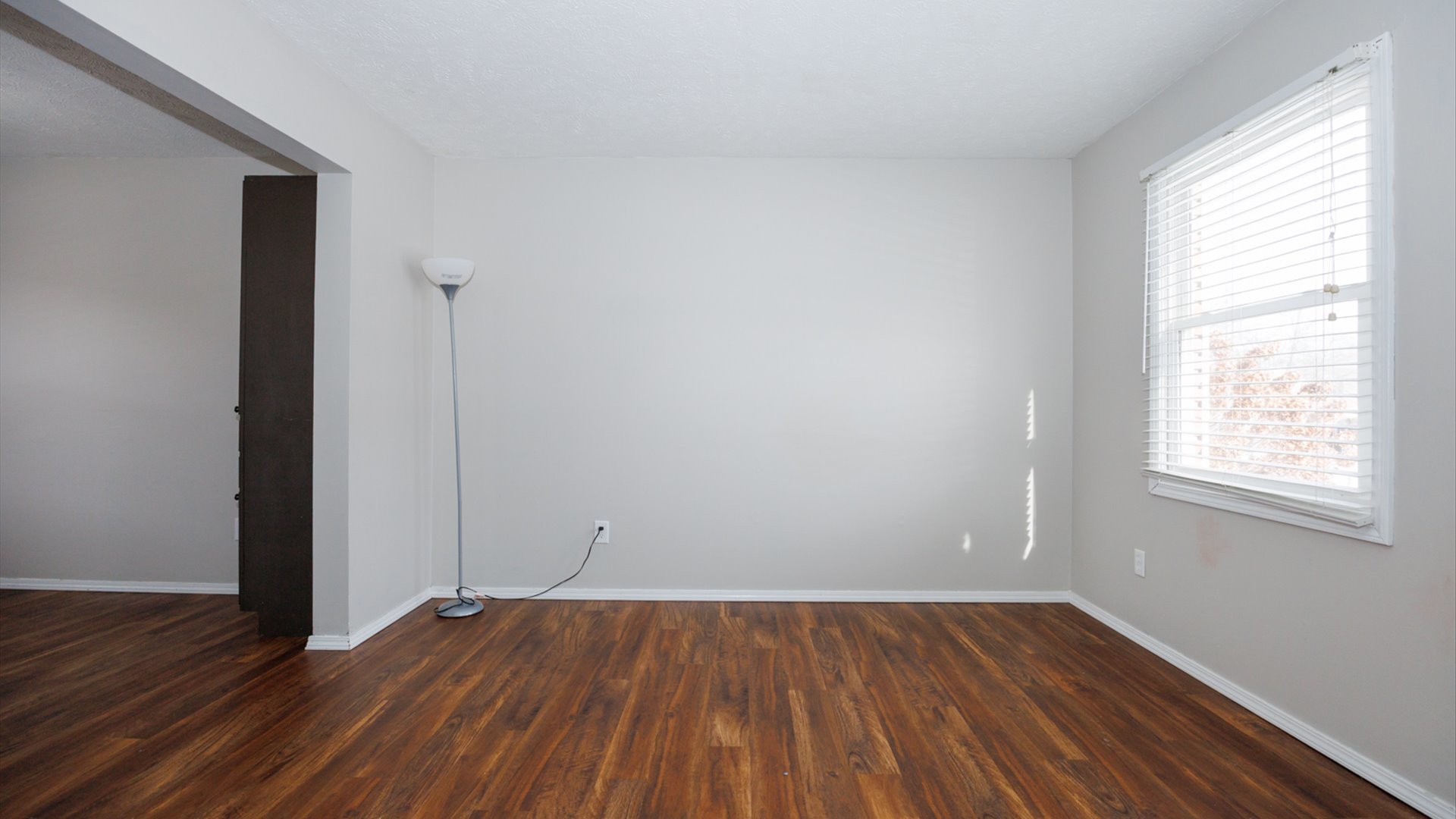 2007 Fallen Oak Road Bloomington, IL 61704 - Photo 5 of 44 an empty room with wooden floor and windows