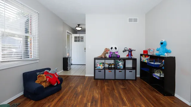 a living room with furniture and a wooden floor