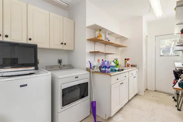 a kitchen with granite countertop white cabinets and white appliances