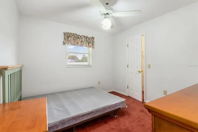 a view of room with window and ceiling fan