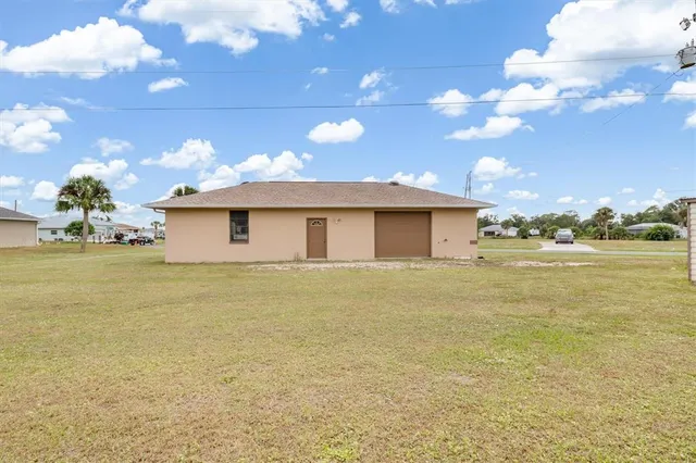 a view of a house with a yard and lake view