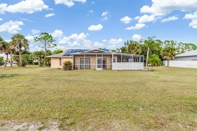 a view of a house with a big yard and potted plants