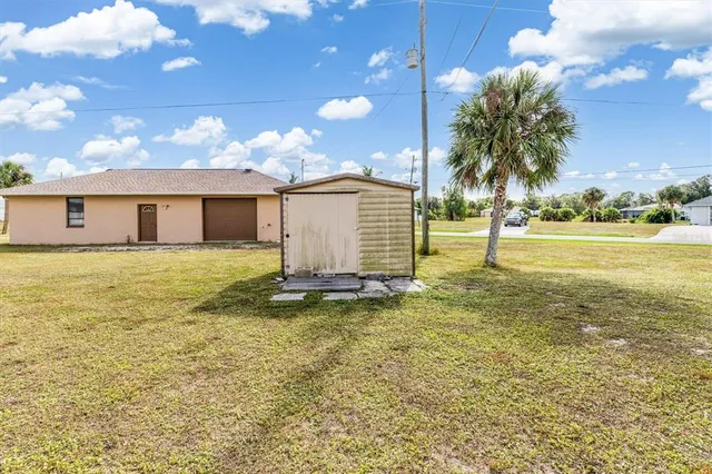 a view of a house with a yard and swimming pool