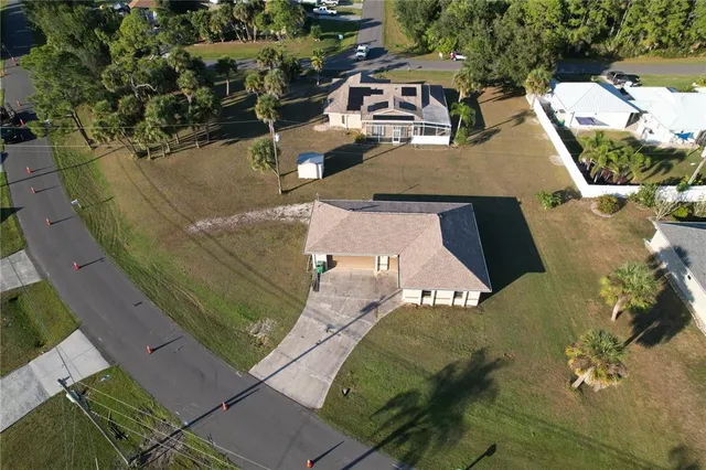 an aerial view of a house with a yard