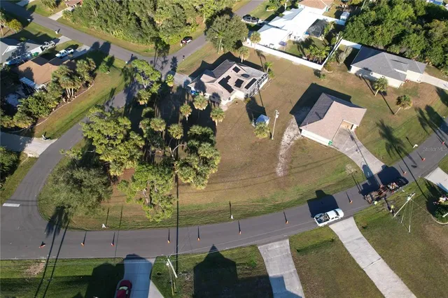 an aerial view of a house with a yard
