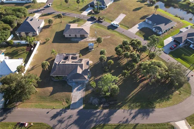 an aerial view of a house with a yard