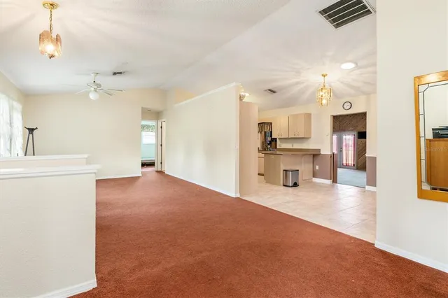 a view of a kitchen with a sink and a refrigerator a chandelier