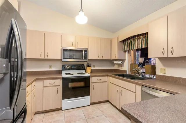 a kitchen with a sink stove and microwave