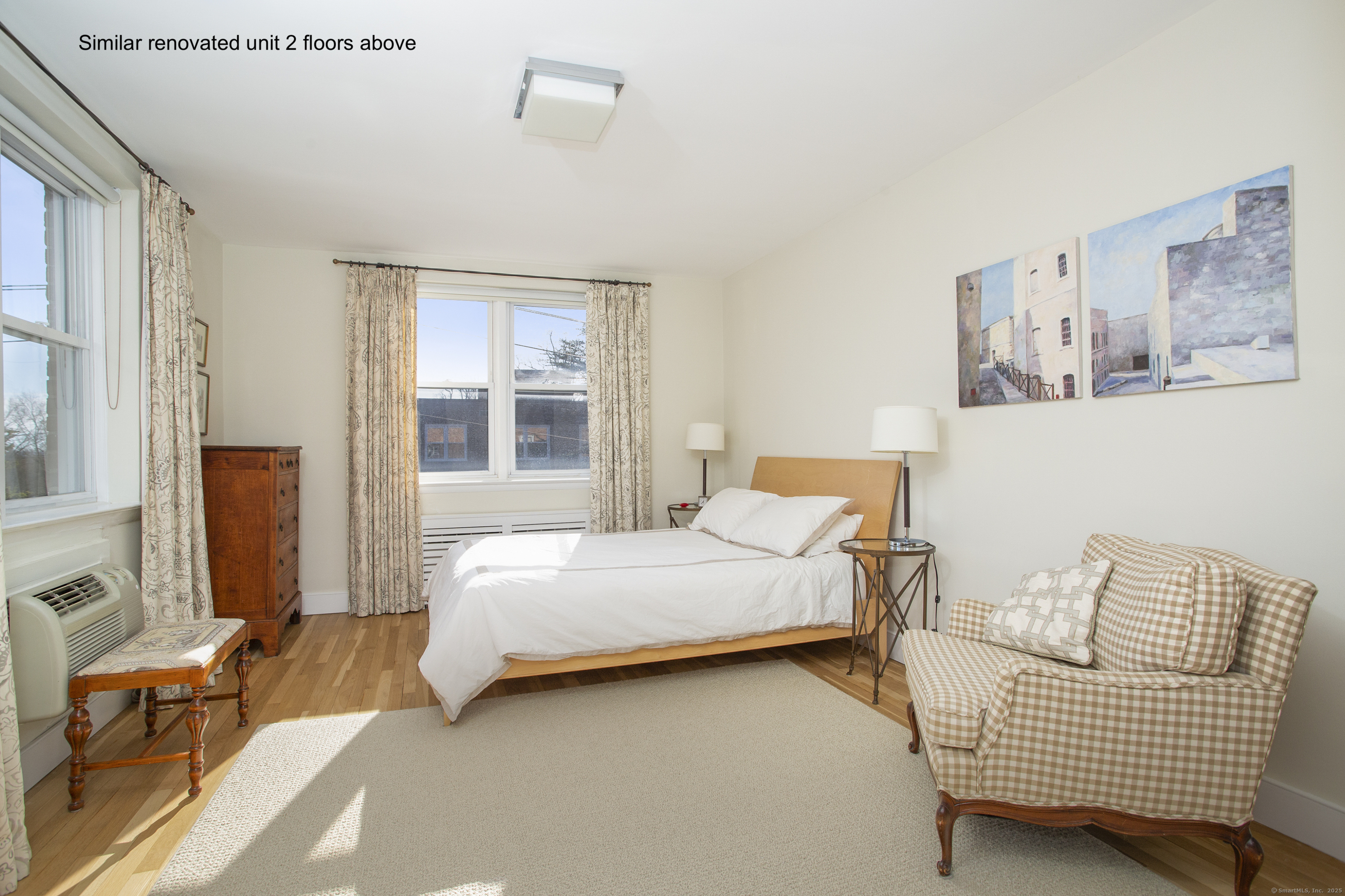 4 Putnam Hill, Unit 1C Greenwich, CT 06830 - Photo 11 of 29 a bedroom with a bed and wooden floor