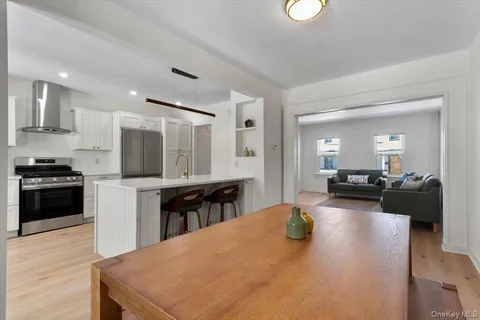 a kitchen with a refrigerator and a stove top oven