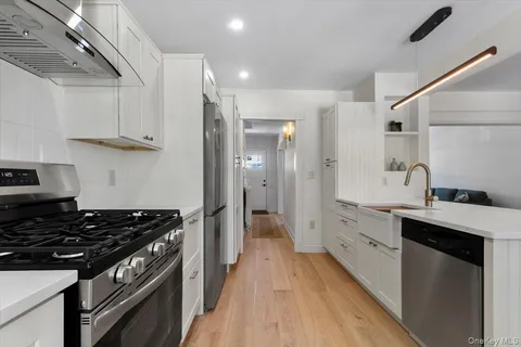 a kitchen with stainless steel appliances a sink dishwasher stove and refrigerator