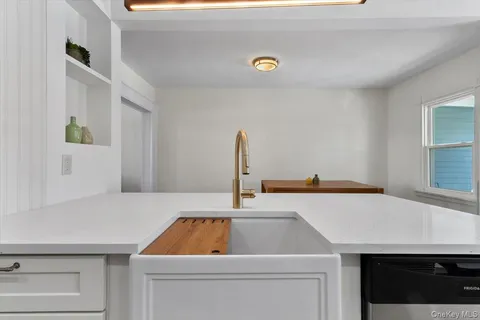 a room with a sink cabinets and window