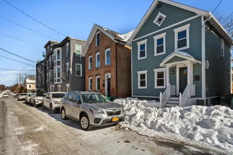 a car parked in front of a brick house