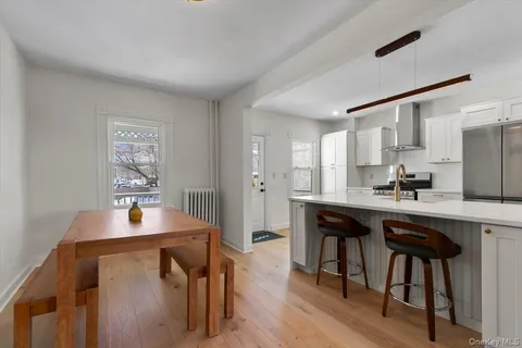 a kitchen with a table chairs refrigerator and cabinets