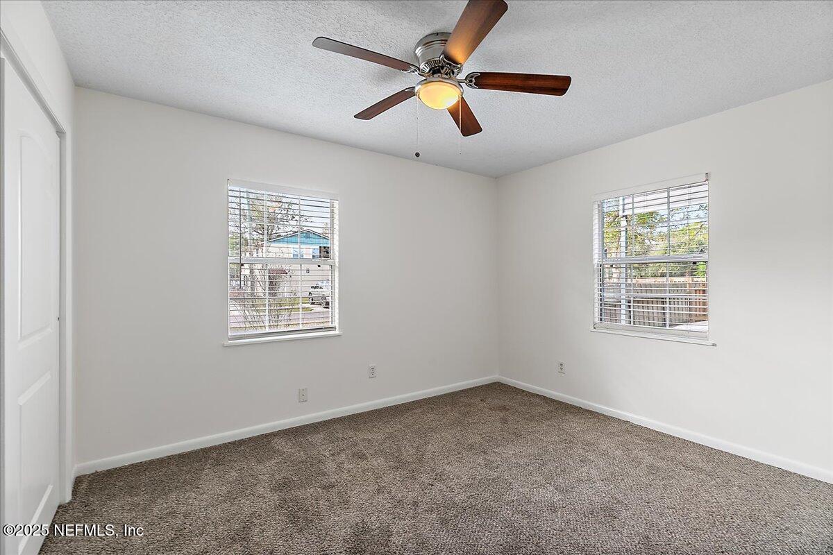 1879 George Street Atlantic Beach, FL 32233 - Photo 13 of 27 an empty room with a window and a fan