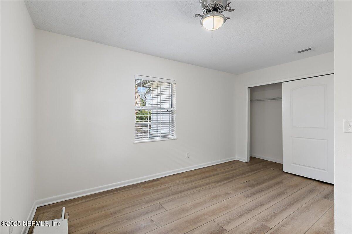 1879 George Street Atlantic Beach, FL 32233 - Photo 14 of 27 wooden floor in an empty room with a window