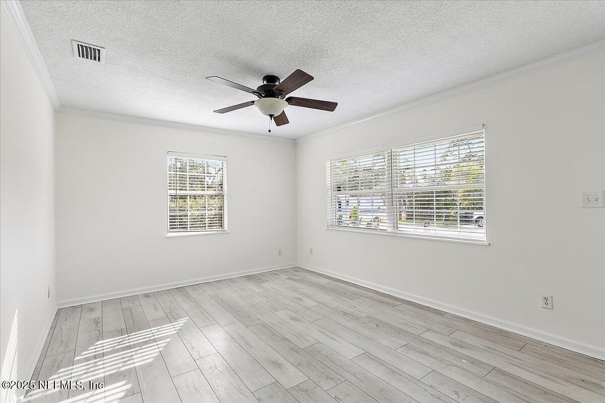 1879 George Street Atlantic Beach, FL 32233 - Photo 4 of 27 a view of an empty room with a window and a chandelier fan
