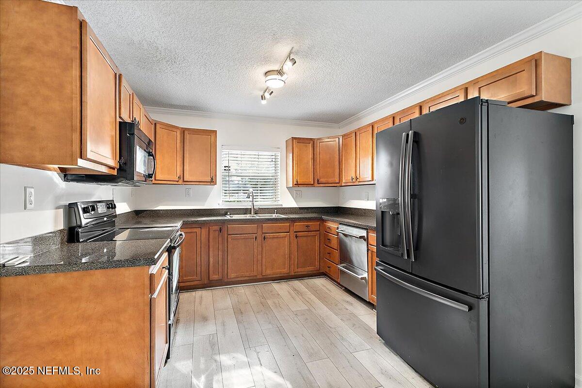 1879 George Street Atlantic Beach, FL 32233 - Photo 6 of 27 a kitchen with stainless steel appliances granite countertop a refrigerator a sink dishwasher a stove top oven a refrigerator and cabinets