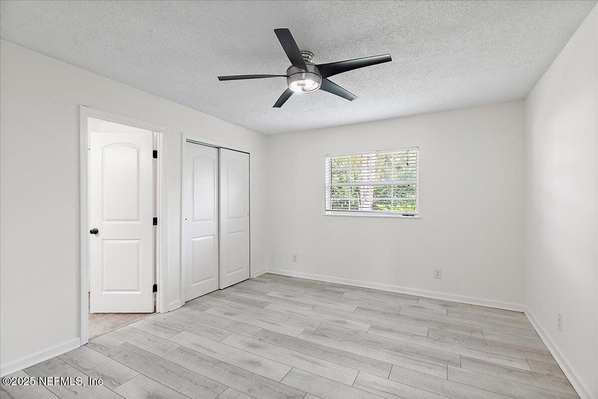1879 George Street Atlantic Beach, FL 32233 - Photo 9 of 27 a view of an empty room with a ceiling fan