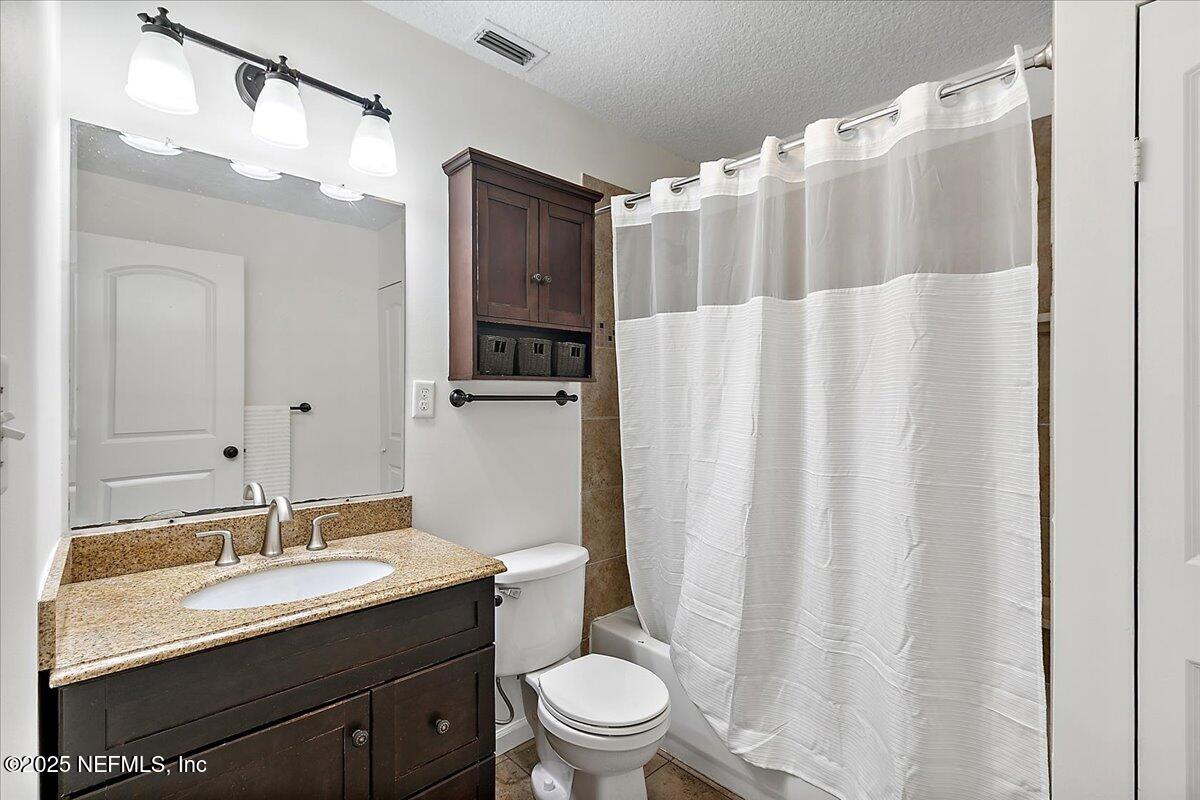 1879 George Street Atlantic Beach, FL 32233 - Photo 10 of 27 a bathroom with a granite countertop sink toilet and shower