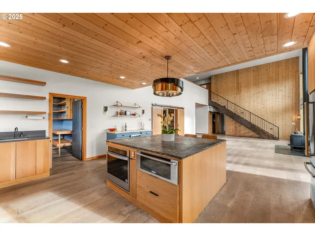 a kitchen with stainless steel appliances granite countertop a sink and a stove