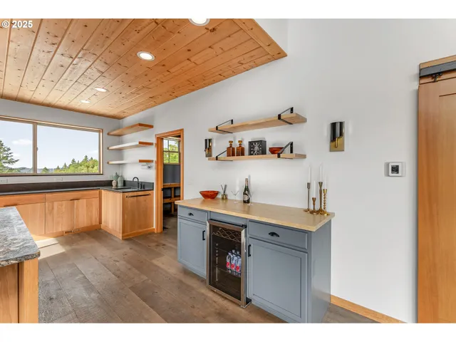a kitchen that has a lot of cabinets and wooden floor