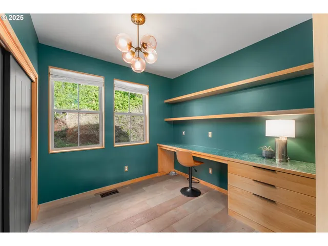 a room with pool table and windows