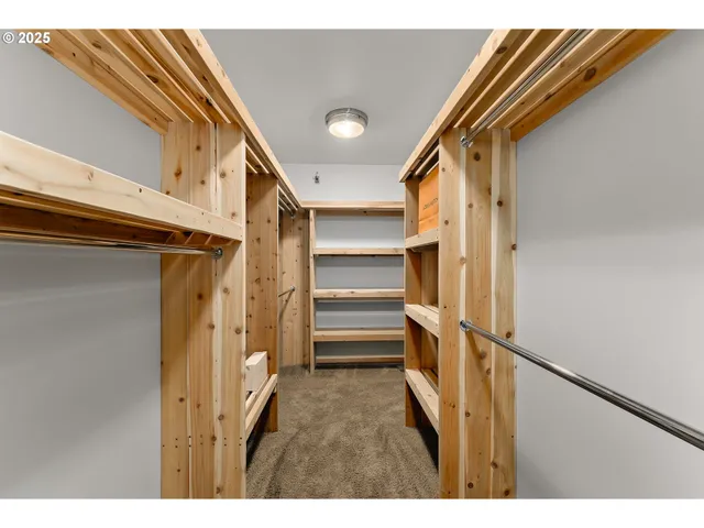 a view of walk in closet with empty racks