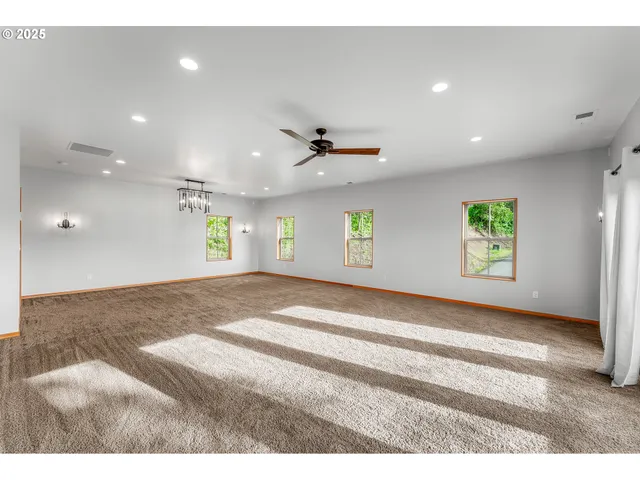 a view of an empty room and a window