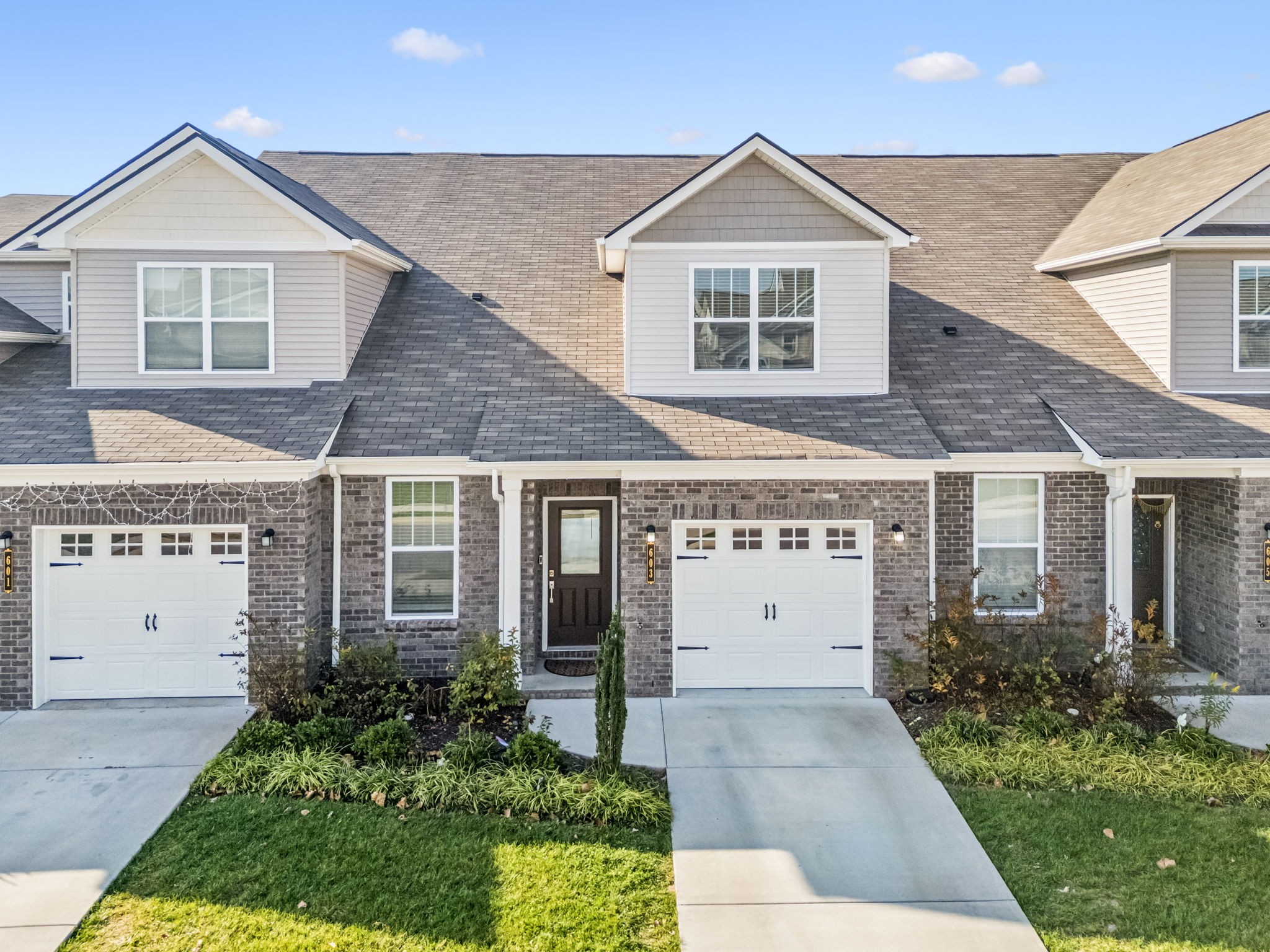 603 Birdie Dr Spring Hill Spring Hill, TN 37174 - Photo 1 of 26 a view of white house with a small yard and potted plants