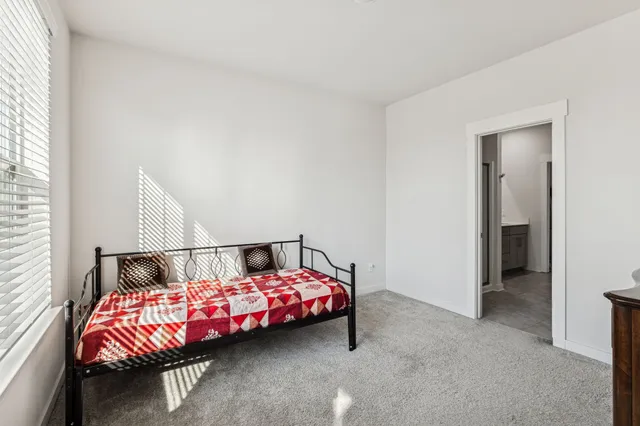 a bedroom with bed and a window