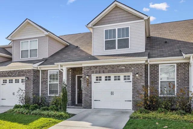 a view of a house with a yard and plants