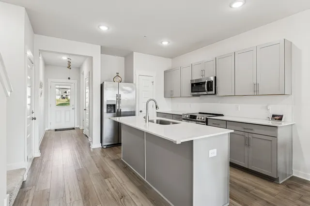 a kitchen with a sink stove and refrigerator