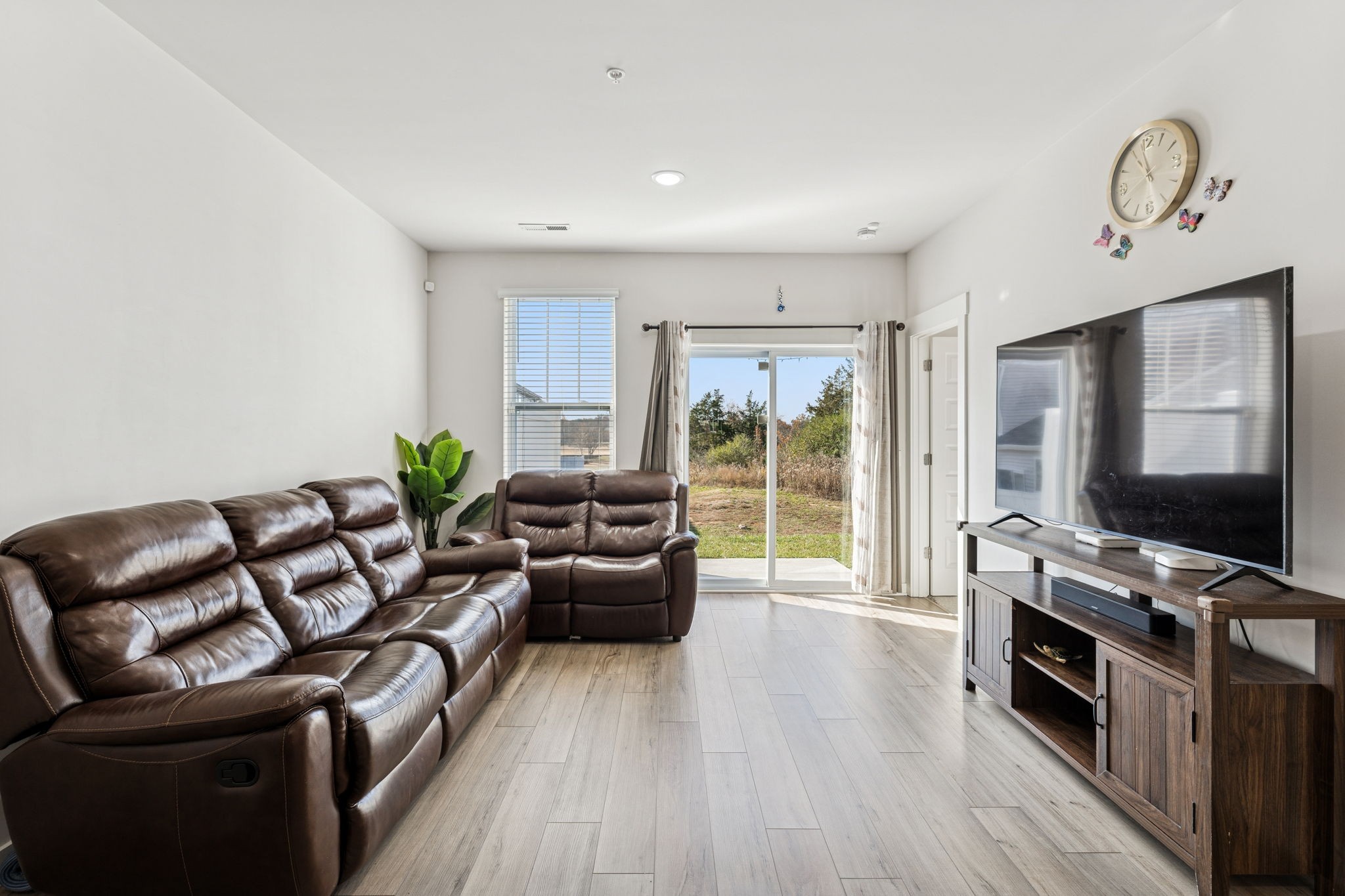 603 Birdie Dr Spring Hill Spring Hill, TN 37174 - Photo 10 of 26 a living room with furniture a flat screen tv and a floor to ceiling window