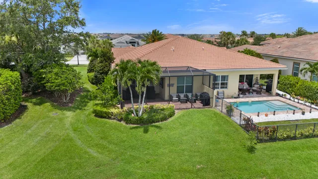 a view of house with swimming pool outdoor seating and yard