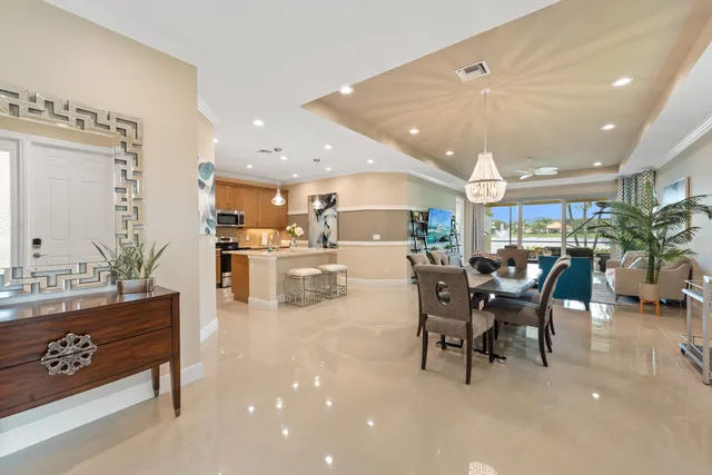a dining room with kitchen island a table and chairs