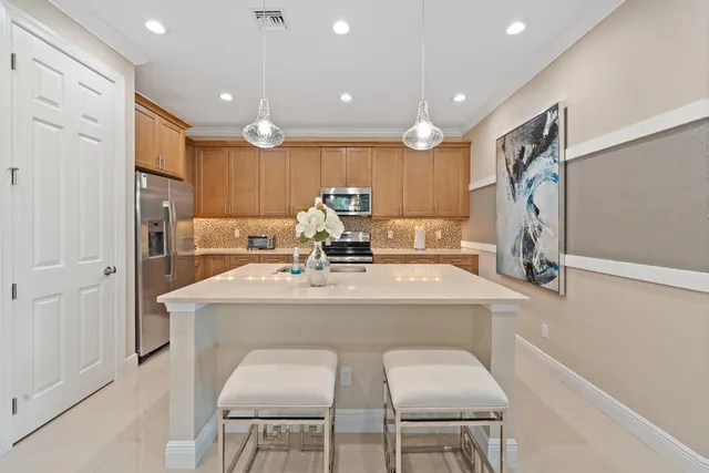 a kitchen with a table chairs refrigerator and microwave